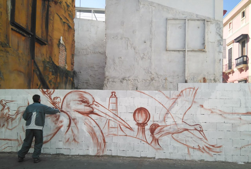 Las cigüeñas de Fran Mesa hacen un guiño social a la migración y a un mundo sin fronteras en el muro de la calle Palacios