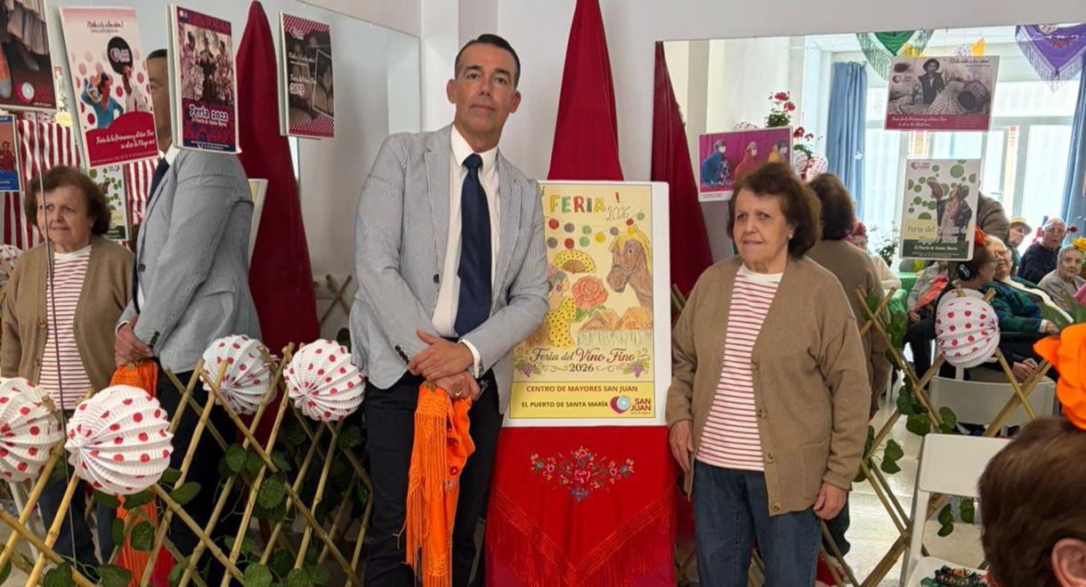 El Centro de Mayores San Juan presenta su cartel de la Feria de El Puerto 2026 junto al teniente alcalde de Fiestas, David Calleja